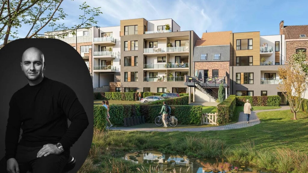 Modern apartment complex with balconies, a landscaped lawn, pond, and a large grayscale portrait of a man on the left.